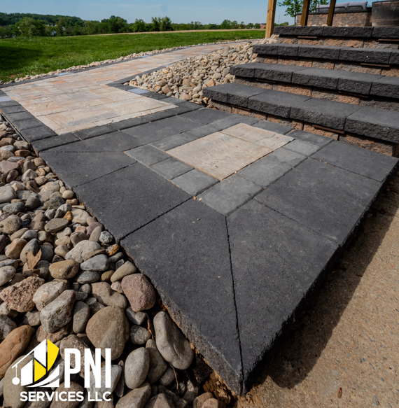 Paver steps with rock edging. Gray and beige paver steps and walkway with decorative stone edging.
