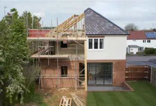 Creativity in residential projects: turning ideas into unique structures Residential house under construction with wood and brick framework