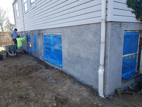 Stucco being applied to the exterior wall of a modern home
